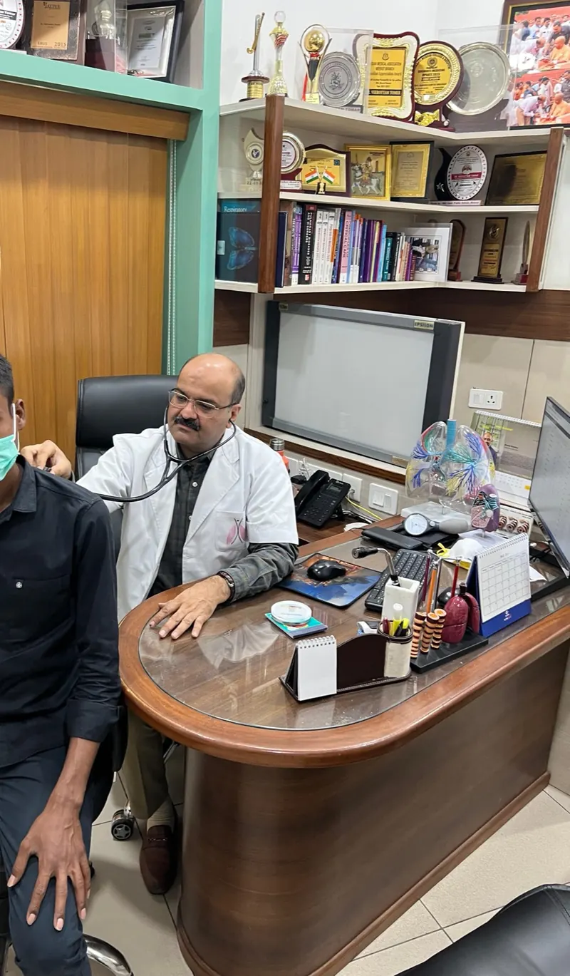 Dr. Tomer examining a patient at his desk