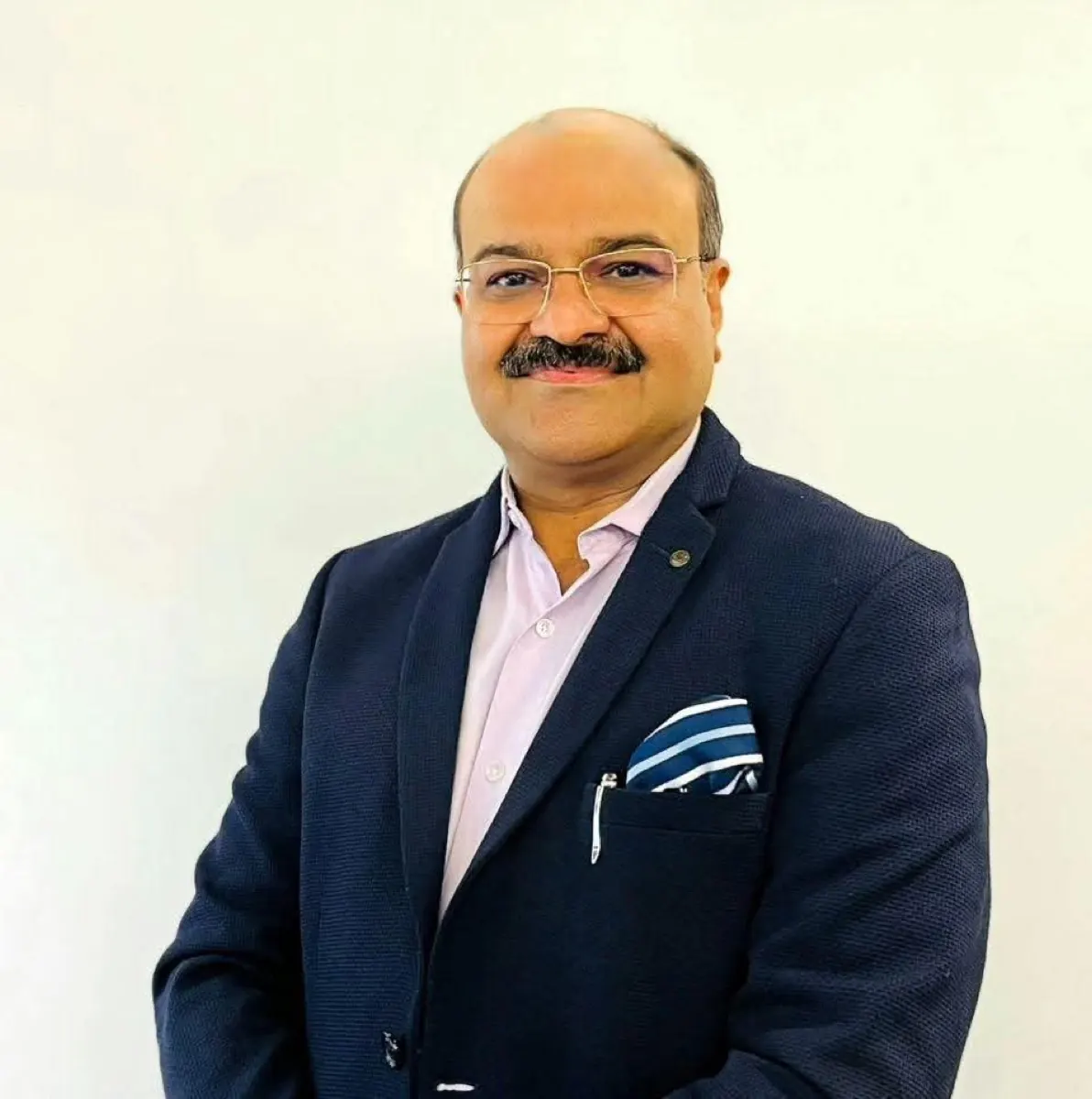 Dr. Veerottam Tomer in a navy blazer